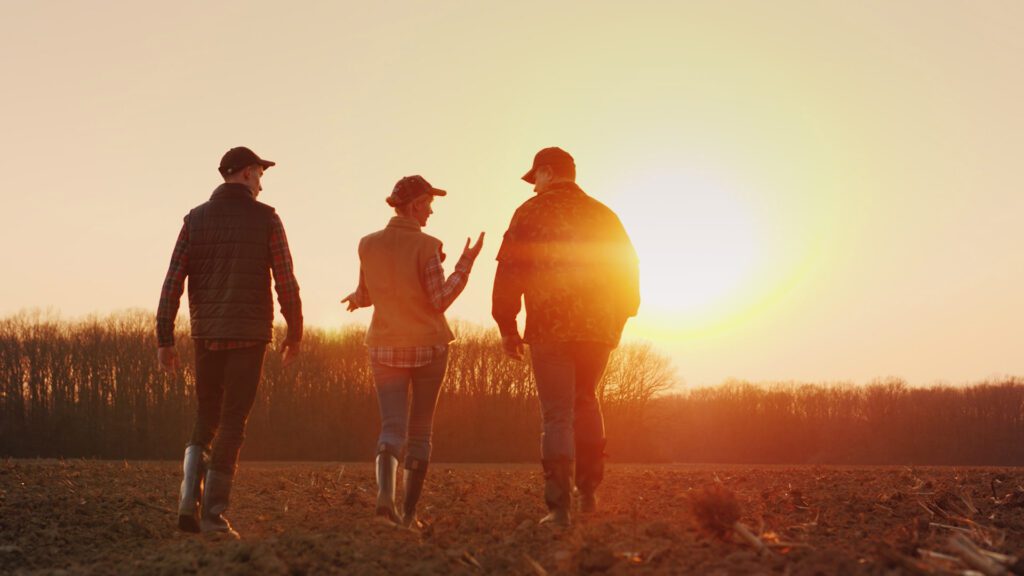 farmers walking sunset