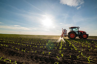 tractor spraying corn